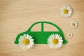 Paper car cut-out with daisy flowers - Eco-friendly car concept