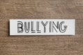 Paper card with word Bullying on table, top view Royalty Free Stock Photo