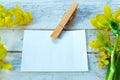 Paper card and Yellow daffodils on rustic wooden table. Top view, copy space Royalty Free Stock Photo