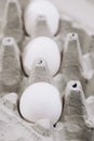 Paper cardboard box egg tray lies on table with demanding white eggs. Royalty Free Stock Photo