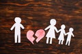 Paper chain cut family with broken heart on wooden background. Divorce and broken family concept Royalty Free Stock Photo