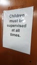 Paper children must be supervised at all times on wood wall