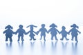 Paper children standing together hand in hand. Royalty Free Stock Photo