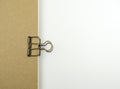 Paper clip on brown notebook.