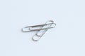 Paper clip on floor white background. Is device used to collect small number