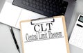 Paper clipboard with CLT on laptop with pen and calculator Royalty Free Stock Photo