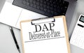 Paper clipboard with DAP on laptop with pen and calculator Royalty Free Stock Photo