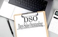 Paper clipboard with DSO on laptop with pen and calculator Royalty Free Stock Photo