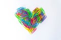 Paper clips lined in heart shape on white background Royalty Free Stock Photo