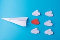 Paper clouds (one red) and a plane on a blue background. Ctext sapce Royalty Free Stock Photo