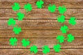 Paper clover leaves on the old wooden background. St.Patrick`s day holiday symbol. Space for text, top view Royalty Free Stock Photo
