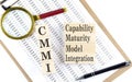 Paper with CMMI - Capability Maturity Model Integration a table on charts, business concept Royalty Free Stock Photo