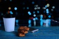 Paper coffee cup, biscuits and telephone on a wooden table Royalty Free Stock Photo