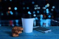 Paper coffee cup, biscuits and telephone on a wooden table Royalty Free Stock Photo