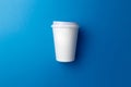 Paper coffee Cup on a classic blue background. The concept of Breakfast and coffee. Take the drink with you. Ecological tableware. Royalty Free Stock Photo