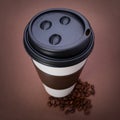 Paper Coffee cup with Coffee Beans on brown background. Takeaway Royalty Free Stock Photo