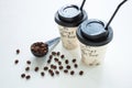 Paper coffee cup from coffee shop with coffee beans near the window. Lifestyle concept