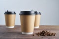 Paper coffee disposable cup for take away or to go, wooden table, space for design mock-up Royalty Free Stock Photo