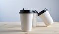 Paper coffee disposable cup for take away or to go, wooden table, space for design mock-up Royalty Free Stock Photo