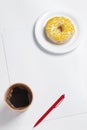 Paper, coffee and donut