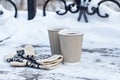 paper craft glass, cup with a hot drink, coffee, cocoa, mulled wine and white and black mittens