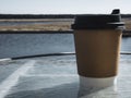 Paper cup of coffee background with view. Film effect