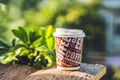 A paper cup with coffee on an old wooden background Royalty Free Stock Photo