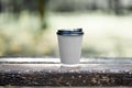 Paper cup of coffee outdoors, coffee break banner