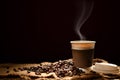 Paper cup of coffee with smoke and coffee beans Royalty Free Stock Photo