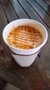 Paper cup of hot caramel macchiato