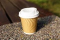 Paper cup on parapet outdoors, closeup. Coffee to go Royalty Free Stock Photo