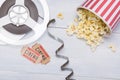 Paper cup with popcorn, scattered next to the film and tickets for a movie session Royalty Free Stock Photo