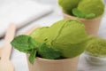 Paper cup with tasty matcha ice cream on table, closeup Royalty Free Stock Photo