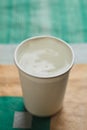 Paper cup a white color, on table on bright background