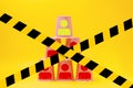 Paper cups laid out in the form of a pyramid, with the image of the symbols of the little man. Blocked by a barrier tape. Yellow Royalty Free Stock Photo