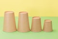 Paper cups in yellow and green background Royalty Free Stock Photo