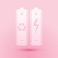 Paper cut Battery with recycle symbol - renewable energy concept icon isolated on pink background. Paper art style Royalty Free Stock Photo