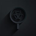 Paper cut Biohazard and magnifying glass icon isolated on black background. Paper art style. Vector Royalty Free Stock Photo