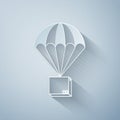 Paper cut Box flying on parachute icon isolated on grey background. Parcel with parachute for shipping. Delivery service