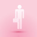 Paper cut Businessman man with briefcase icon isolated on pink background. Paper art style. Vector Royalty Free Stock Photo