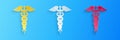 Paper cut Caduceus medical symbol icon isolated on blue background. Medicine and health care concept. Emblem for drugstore or Royalty Free Stock Photo