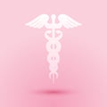 Paper cut Caduceus medical symbol icon isolated on pink background. Medicine and health care concept. Emblem for Royalty Free Stock Photo