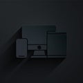 Paper cut Computer monitor, graphic tablet and mobile phone icon isolated on black background. Earnings in the Internet