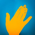 Paper cut concept of three fingers hugging themselves.