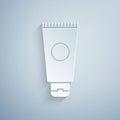 Paper cut Cream or lotion cosmetic tube icon isolated on grey background. Body care products for men. Paper art style