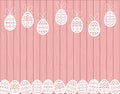 Paper cut Easter eggs hanging on pink Wooden background