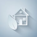 Paper cut Eco friendly house icon isolated on grey background. Eco house with leaf. Paper art style Royalty Free Stock Photo