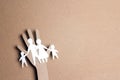 Paper cut family silhouette in a cardboard hand Royalty Free Stock Photo