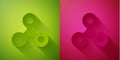 Paper cut Fidget spinner icon isolated on green and pink background. Stress relieving toy. Trendy hand spinner. Paper Royalty Free Stock Photo