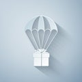 Paper cut Gift box flying on parachute icon isolated on grey background. Delivery service, air shipping concept, bonus Royalty Free Stock Photo